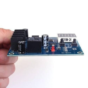 XH-M603-M632 Battery Charging Control Module DC 12V-24V Voltage Charging Discharge Monitor Relay Switch Battery Protection Board - a blue circuit board with a black relay, a red LED, two push buttons, and a digital display held in a hand.