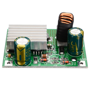 XK-539 5V 3A Buck Converter DC 9V 12V 24V 36V 48V 72V 84V 90V TO 5V 3A Step Down Module Power Supply DC DC Converter Buck Converter Step Up Converte - a green PCB, a silver heatsink, two cylindrical capacitors, a copper coil, and labeled input and output pads.