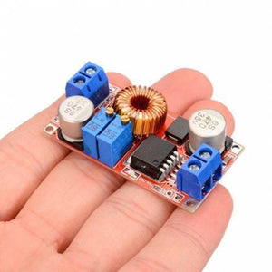 XL4015 Step-down Buck Charging Board DC 0.8-30V To 5-32V - a red circuit board held in a hand featuring two blue screw terminals, two blue potentiometers, and a coil.