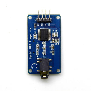 YX5300 MP3 Music Player UART Control Serial Module - a blue rectangular circuit board with a 4-pin header, a headphone jack, and various components.