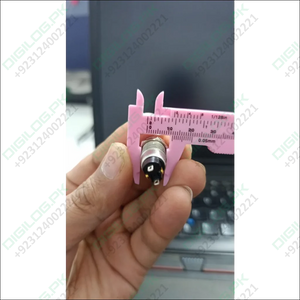 ZLQ-B5V 12mm Waterproof Metal Push ON Push OFF Button Switch With Power Indication - being measured by a pink plastic vernier caliper.