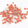0.0001 µF 100pF 0.1nF 101 50V Multilayer ceramic Capacitor - round, orange-coloured ceramic disc capacitors with two metal leads.