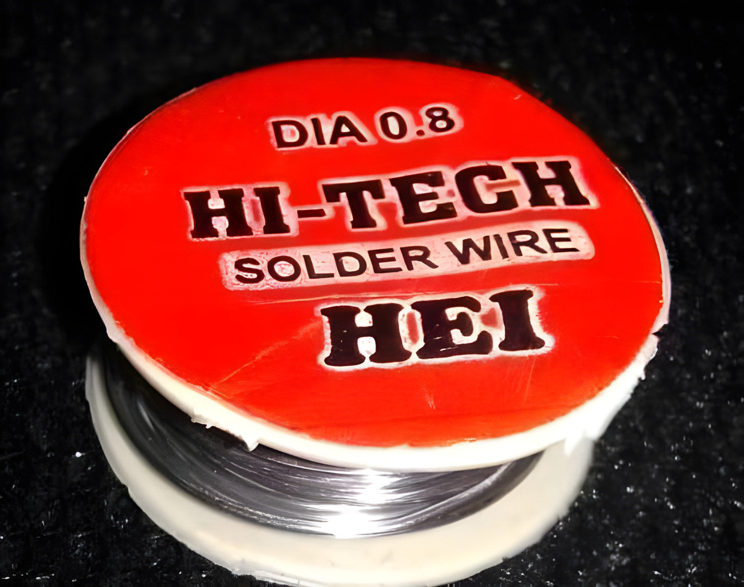 0.8mm 2.5ft Soldering Wire - shown as a close-up of a spool with a red circular label reading "HI-TECH SOLDER WIRE" and "DIA 0.8".