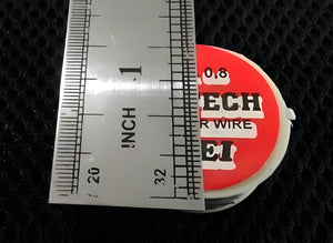 0.8mm 2.5ft Soldering Wire - shown in a close-up top-down view next to a metal ruler measuring its diameter.