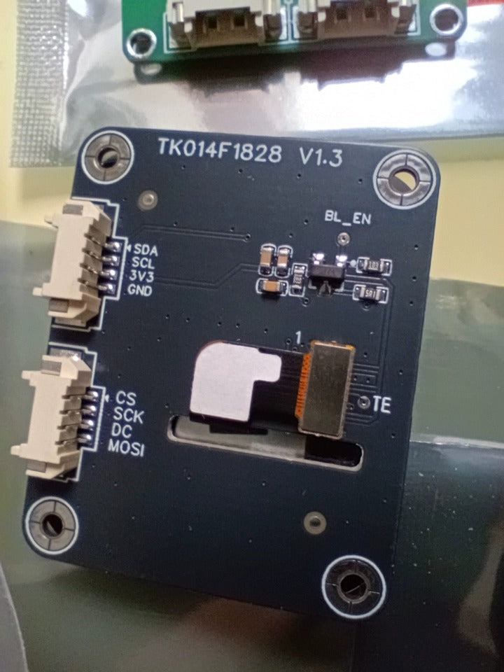 1.4-inch IPS Full-view LCD Screen ESP32 IOT Smartwatch 240x240 Square Capacitive Touchscreen - close-up of the dark blue square circuit board back, showing two white connectors and labels.