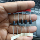 1.5KE400A TVS Diode – 1500W Transient Voltage Suppressor 400V Unidirectional - five black cylindrical electronic components with metal leads held in a hand, showing printed text on their bodies.