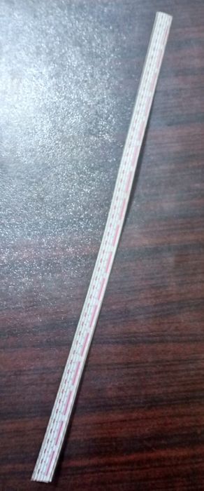 1 Feet 2mm 6 Pin Wire And Connector - a long, thin, white ribbon cable with a 6-pin connector at one end, laid diagonally on a dark wood surface.
