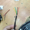 1 Meter 4 Core Signal Cable Sensor Cable - a close-up of the stripped black outer jacket revealing four internal wires colored yellow, green, black, and red.
