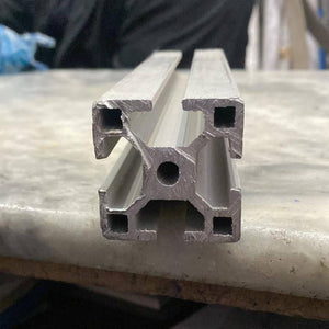 1 Meter 4040 Aluminium Profile Aluminium Extrusion For CNC And 3d Printer Color Black/silver - close-up end view of a silver-coloured aluminium extrusion showing its square cross-section with four T-slots and a central hole.