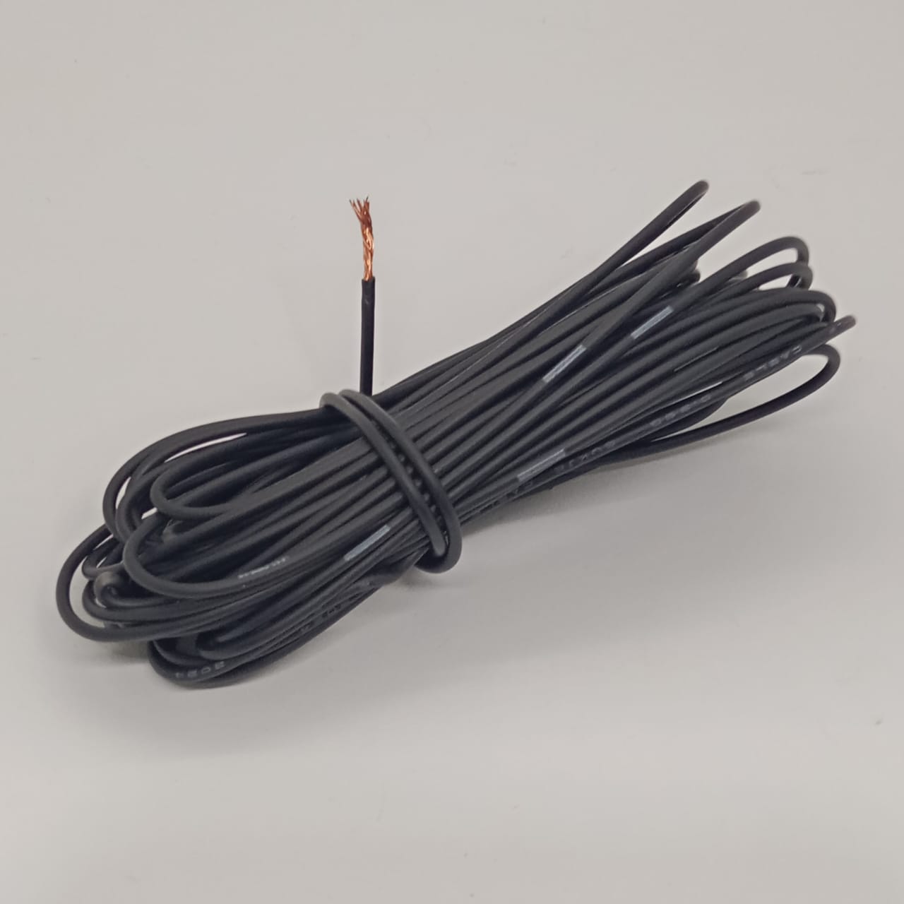 1 Meter Black Solderable Flexible Wire high quality - shown as a single coiled length of black insulated wire with one end stripped to reveal the copper conductor.