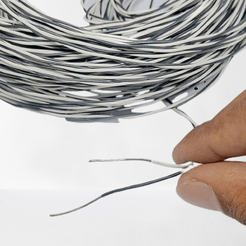 1 Meter Hard Jumper Wires Spiral Wrap Wires Cable - shown as a coiled bundle of black and white wires with a hand holding two stripped wire ends.