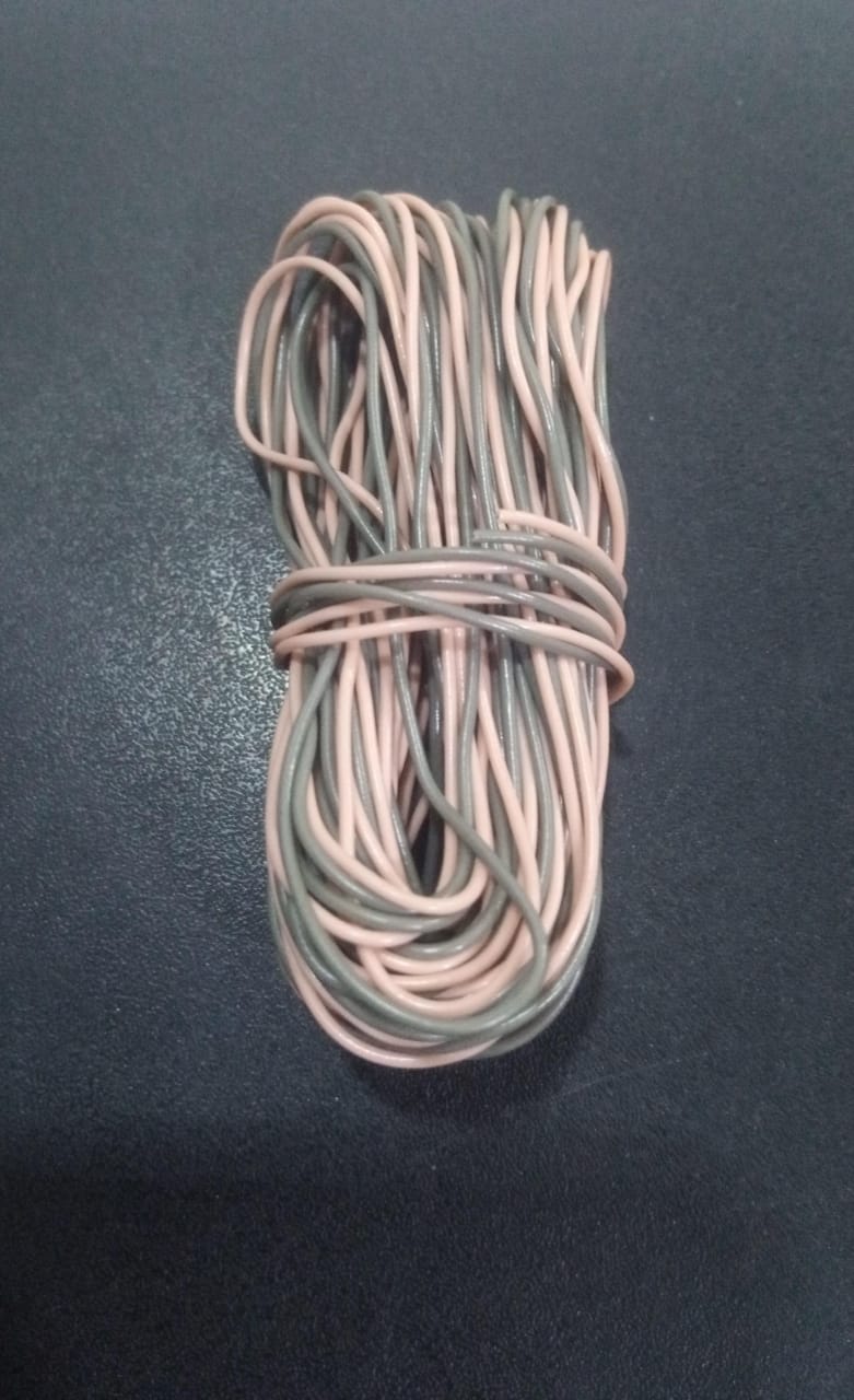 1 Meter Hard Jumper Wires Spiral Wrap Wires Cable - shown as a coiled bundle of alternating pink and grey insulated wires on a dark surface.