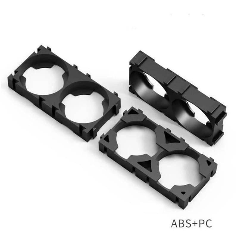 1 Piece 18650 Lithium Cell Battery Holder Bracket - shown as two black plastic dual-cell mounting frames viewed from an elevated angle.