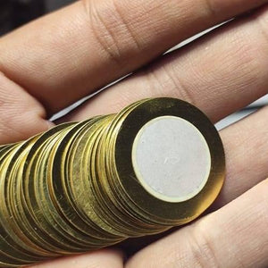 1 Piece 27mm Piezoelectric Transducers Piezoelectric Sensor , Piezo Transducer - a close-up shot of a single round brass-colored sensor with a central white ceramic disc held in a hand.