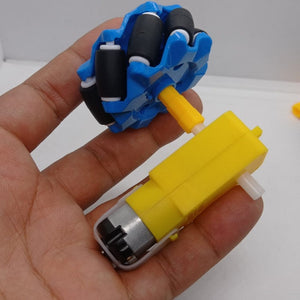 1 Piece 52mm Mecanum Omni Wheels Tires For DIY Rc Robot Toys Tt Motors - shown attached to a yellow TT gear motor held in a hand.