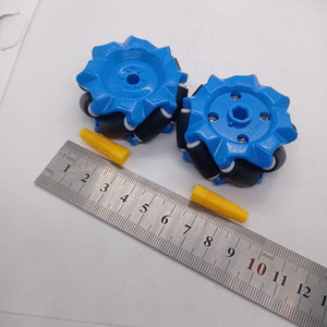 1 Piece 52mm Mecanum Omni Wheels Tires For DIY Rc Robot Toys Tt Motors - two blue wheels with black rollers and two yellow axle connectors placed next to a metal ruler for scale.