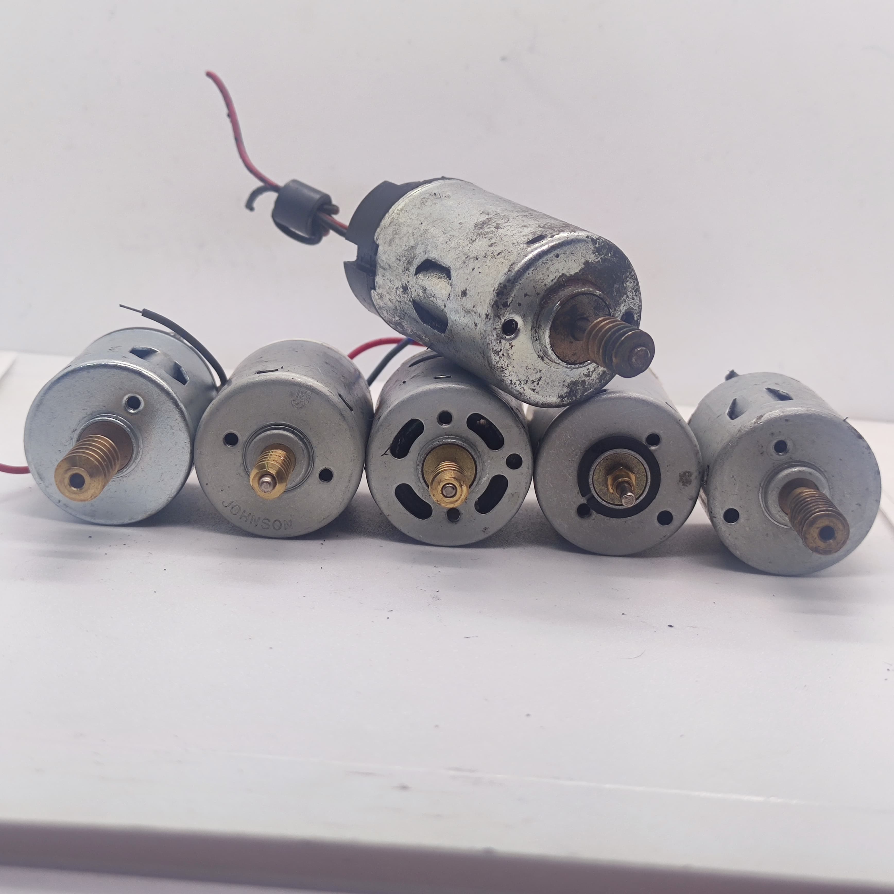 1 Piece Mix Shape DC Motor 3V To 24V Motor Without Wires - five silver cylindrical DC motors with brass threaded shafts arranged on a white surface.