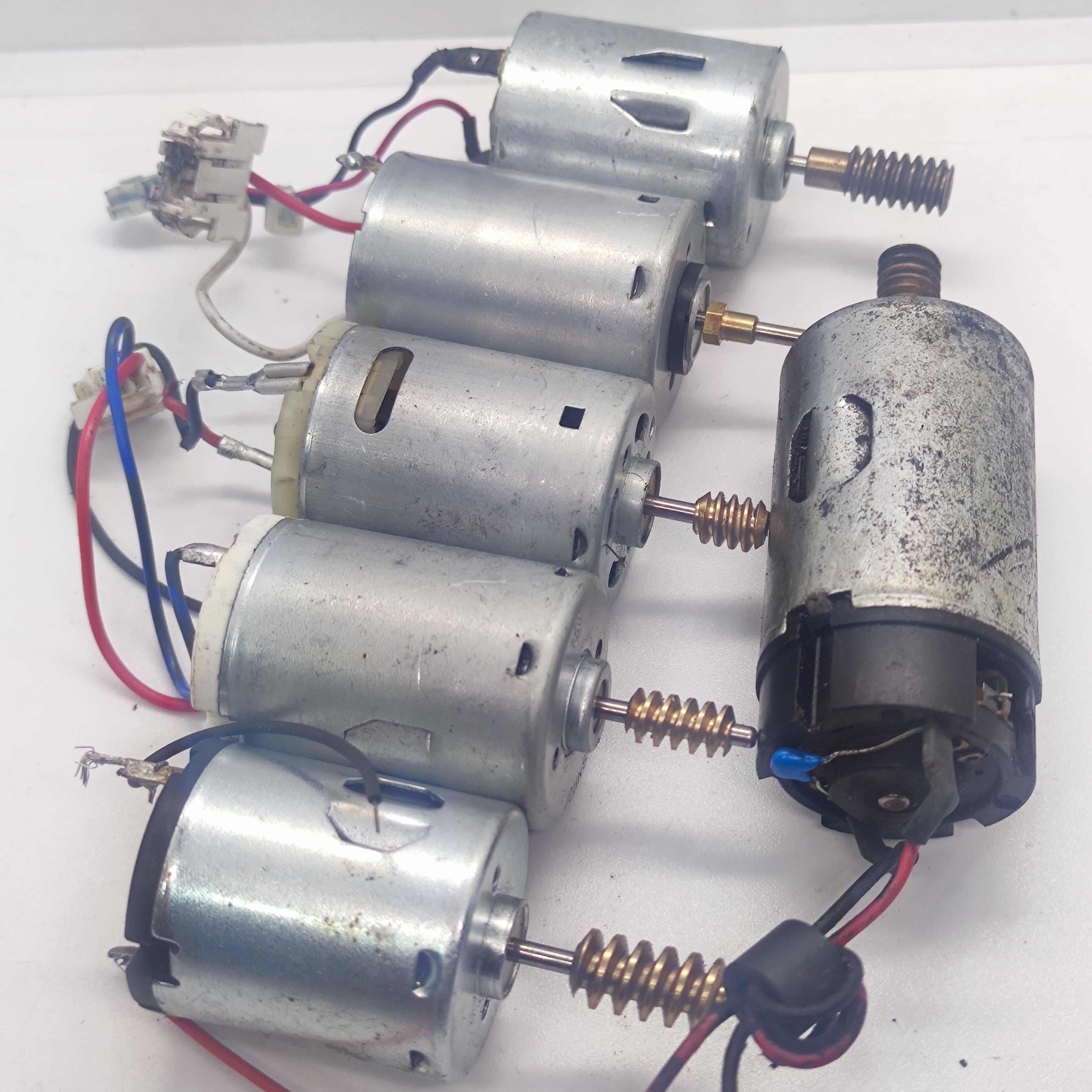 1 Piece Mix Shape DC Motor 3V To 24V Motor Without Wires - collection of five silver cylindrical DC motors with attached brass gears and various wire leads.