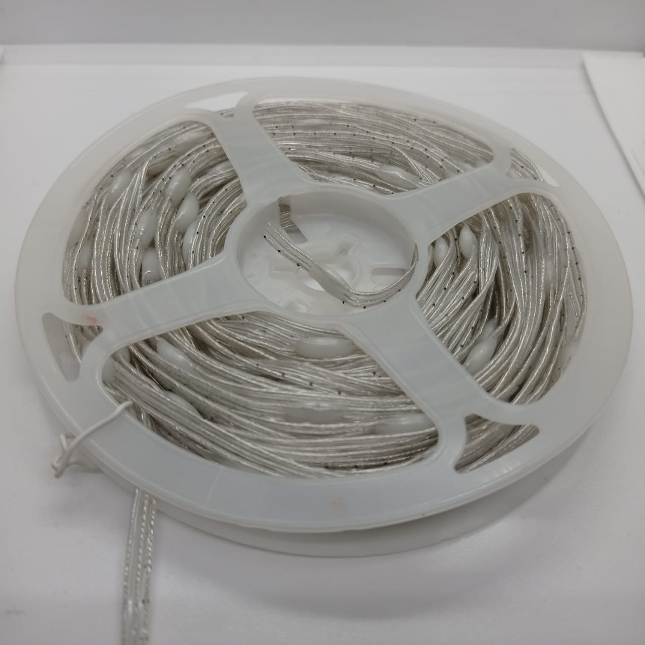 1 Piece RGB Waterproof WS2812 Addressable LED Strip For Arduino (individually Controllable!) - coiled on a white plastic spool, showing the silver wire and white LED components.