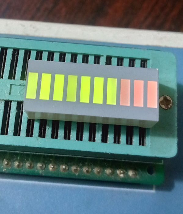 10 Segment LED Light Display Module Bar Graph Ultra Bright Red Yellow Green Colors Multi-color - six green and two red illuminated rectangular segments mounted on a green electronic test socket.