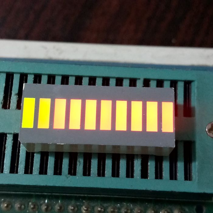 10 Segment LED Light Display Module Bar Graph Ultra Bright Red Yellow Green Colors Multi-color - ten illuminated yellow rectangular segments arranged in a horizontal bar graph on a green test socket.