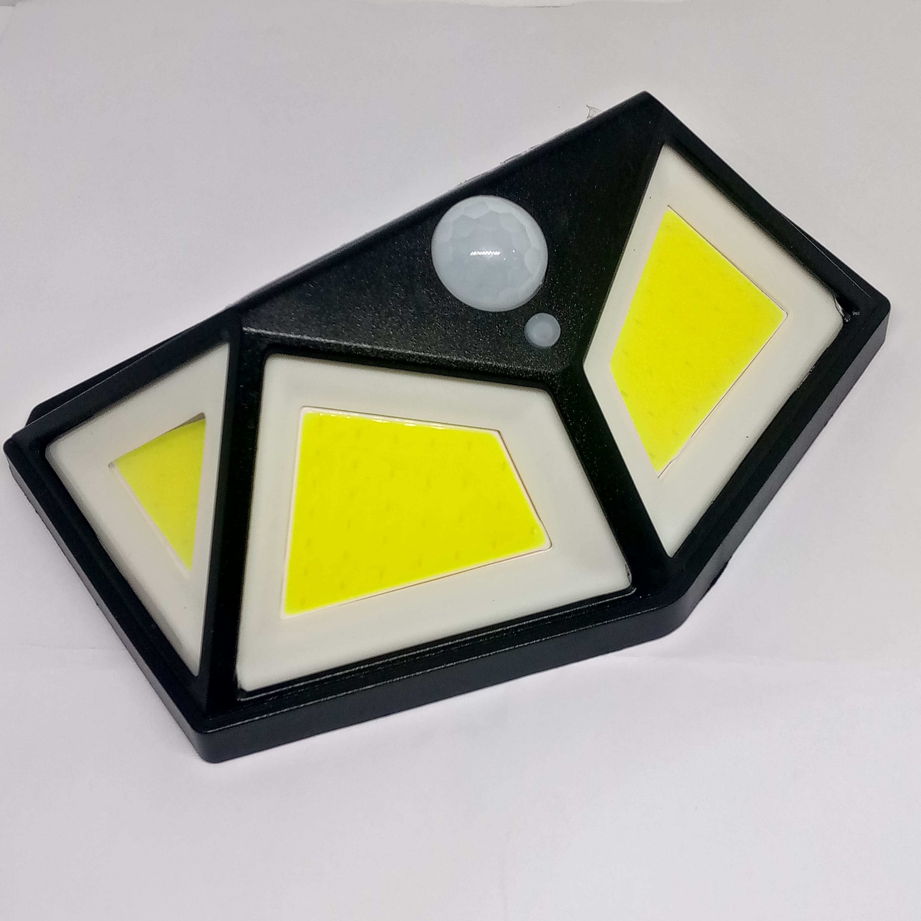 100 LED 4 Surface Solar Light 3 Modes 120 Degree PIR Motion Sensor Light - a black, multi-faceted solar light fixture with three yellow LED panels, a motion sensor, and a small indicator light.