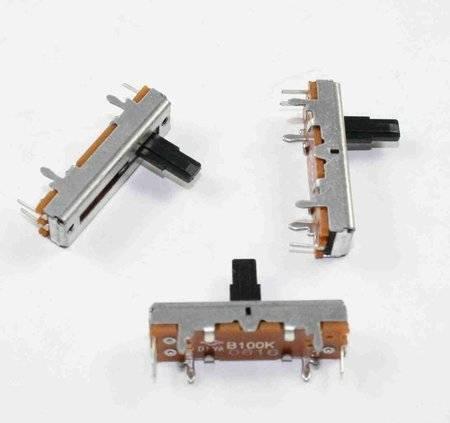 100k Ohm Linear Potentiometer - three silver and brown slide potentiometers with black plastic levers arranged on a white background.