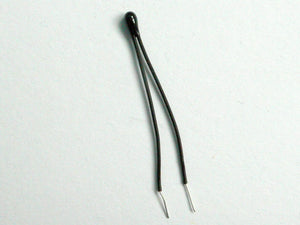 100k Precision NTC Thermistor - shown as a small, black, bead-shaped electronic component with two thin, insulated wire leads extending from the top.