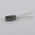 100uF 10V Capacitor - shown as a small black cylindrical electrolytic capacitor with two silver wire leads extending from one end.