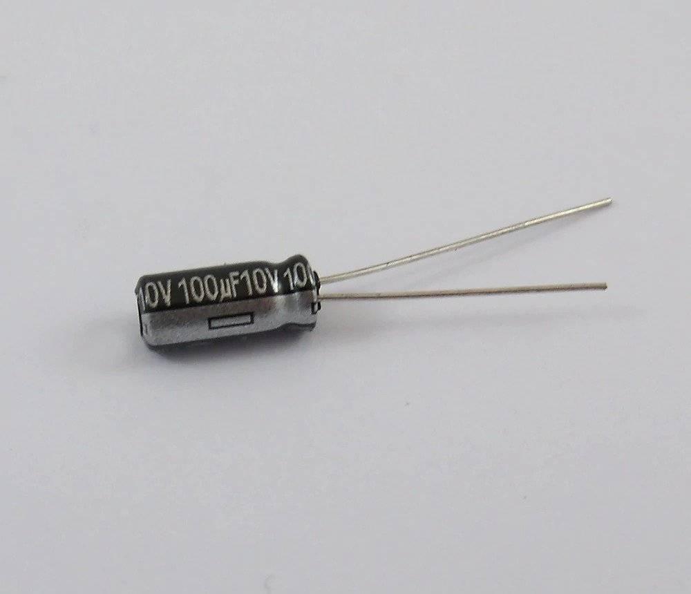 100uF 10V Capacitor - shown as a small black cylindrical electrolytic capacitor with two silver wire leads extending from one end.
