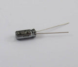 100uF 10V Capacitor - shown as a small black cylindrical electrolytic capacitor with two silver wire leads extending from one end.