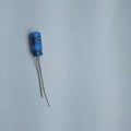100uF 6.3V Electrolytic Capacitor - shown as a single blue cylindrical electronic component with two wire leads extending from the bottom.