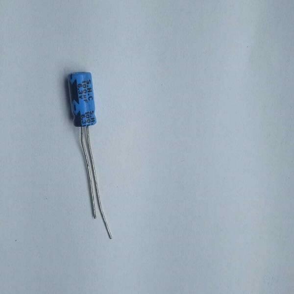100uF 6.3V Electrolytic Capacitor - shown as a single blue cylindrical electronic component with two wire leads extending from the bottom.