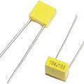 104J100 0.1uF 100V Radial Polyester Box Type Capacitor - shown as two yellow rectangular capacitors with two long metal leads each.