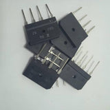 10A Bridge Rectifier - a group of black, rectangular electronic components with four metal pins each, arranged in a scattered pile.