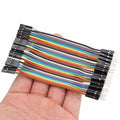 10cm Pin To Hole Jumper Wire Dupont Line 40 Pin Male To Female Arduino Jumper Wires - shown as a multi-colored ribbon cable held in a hand.