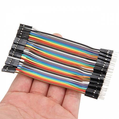 10cm Pin To Hole Jumper Wire Dupont Line 40 Pin Male To Female Arduino Jumper Wires - shown as a multi-colored ribbon cable held in a hand.