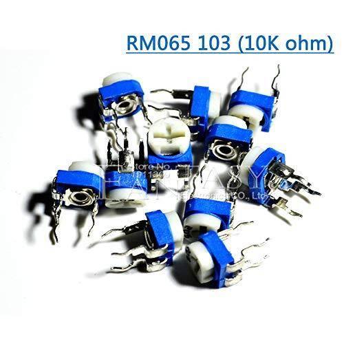 10k RM065 Variable Resistor - shown as a pile of small blue and white circular electronic components with three metal pins and a cross-shaped adjustment slot.
