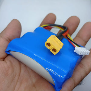 11.1V 3000mAh LiPo Battery For Robotics & Drone - held in a hand, featuring a blue shrink-wrapped pack with a yellow XT60 connector and a white balance charging plug.