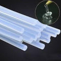11mm Hot Melt Glue Sticks Electric Heating Adhesive Film Craft Glue Stick - show a bundle of translucent cylindrical adhesive sticks with an inset circular close-up of melted glue dripping from a nozzle.