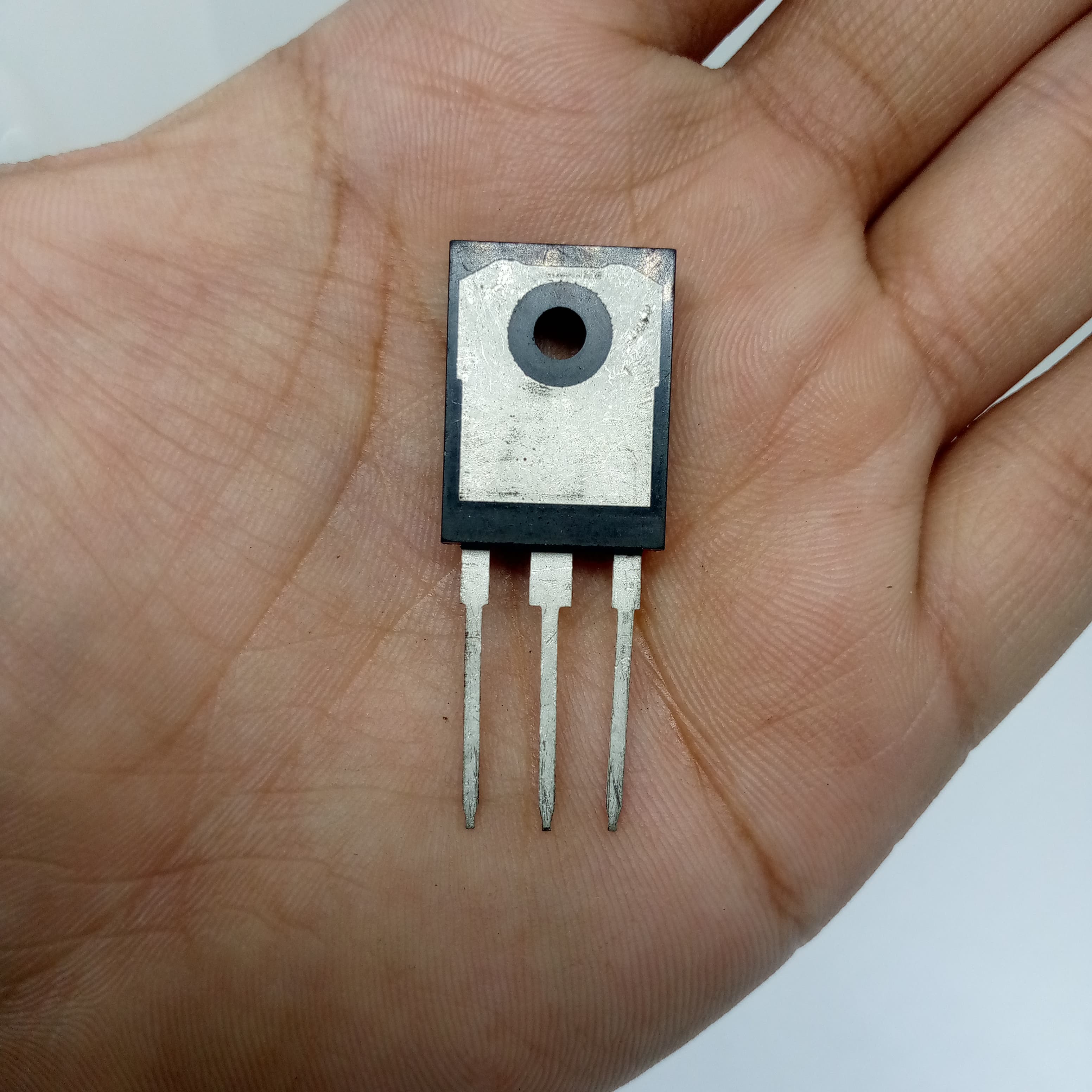 1200V 40A IGBT 40N120 High-performance IGBT - a black and silver three-pin electronic component held in a palm.