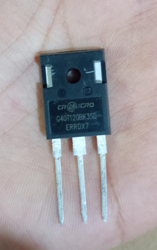 1200V 40amp G40T120 Crmicro IGBT - G40T120BK3SD IGBT, a black rectangular electronic component with three metal pins, held against a person's palm.