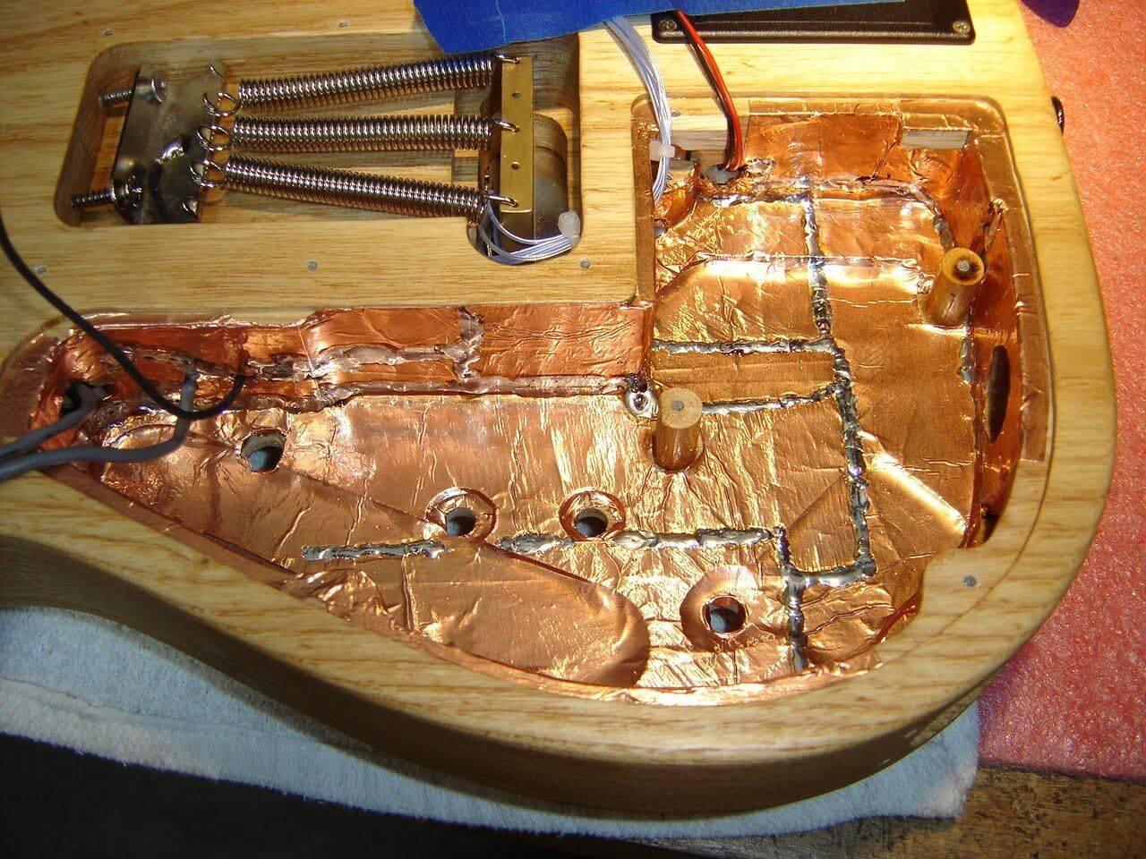 12mm One Sided Copper Foil Conductive Adhesive Tape - applied to the interior cavities of an electric guitar body for electromagnetic shielding.