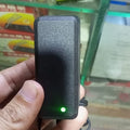 12V 1.5A Power Supply Adapter With Power Indication | Stock Lot - a black rectangular power brick held in a hand, featuring a glowing green power indicator light.