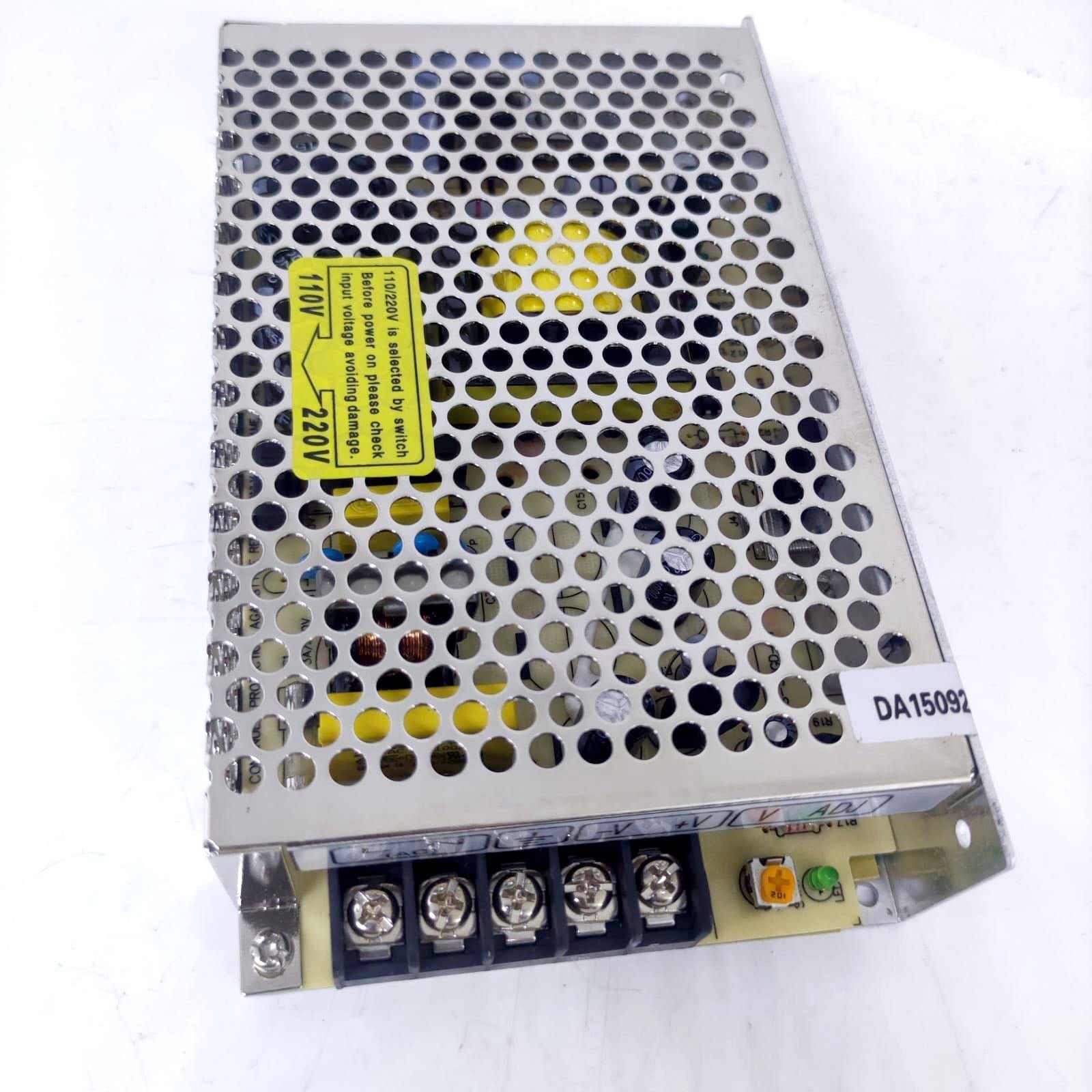 12V 10A Max Well Power Supply - a metallic rectangular unit with a perforated top, a voltage selector warning label, and five screw terminals at the base.