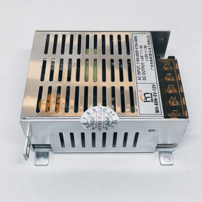 12V 2A And 5V 4A Dual Output DC Power Supply - a silver metal-cased unit with a five-terminal screw connector block and printed specification label.