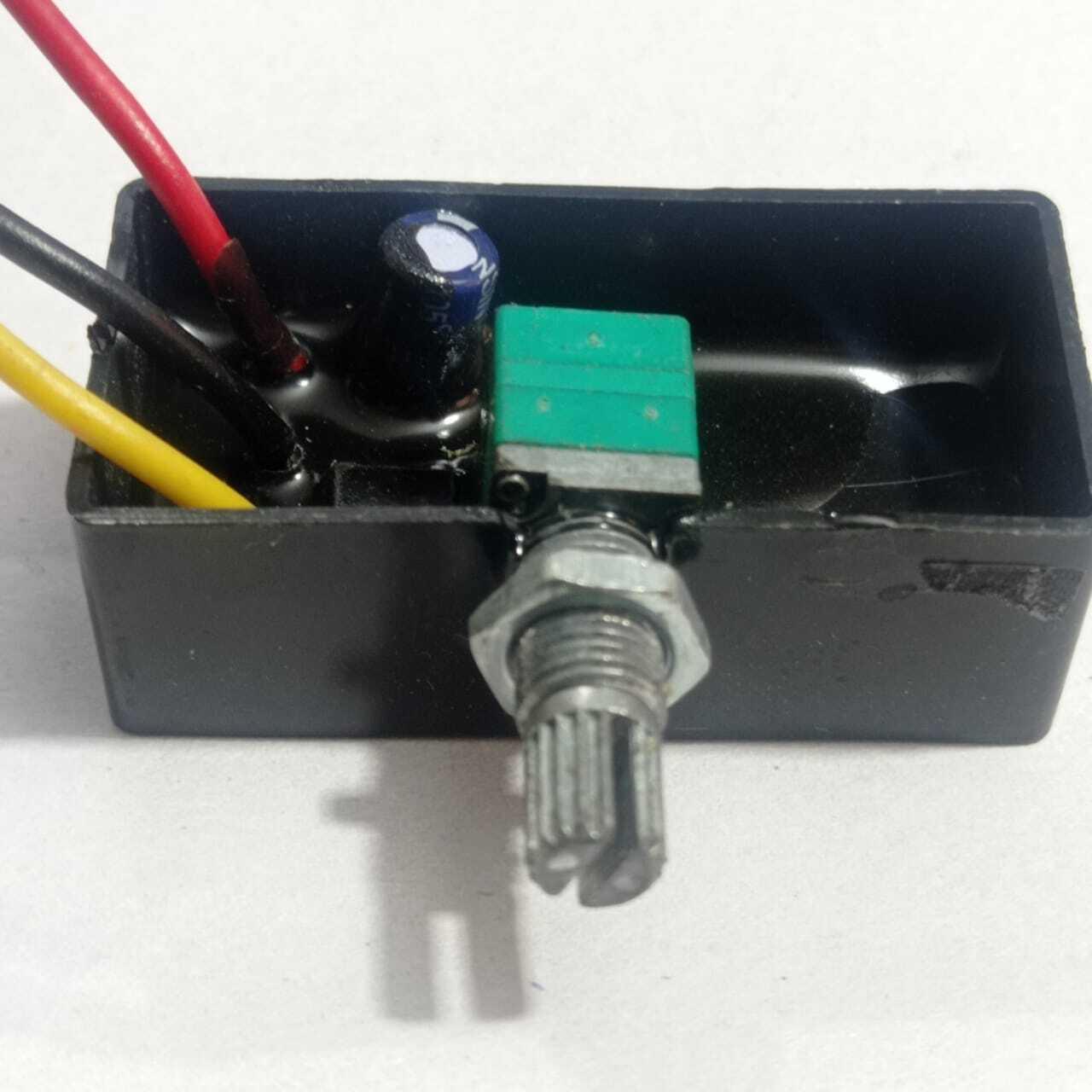 12V 5A DC Dimmer PWM - a black rectangular module with a green potentiometer knob, three wires, and an electrolytic capacitor embedded in resin.