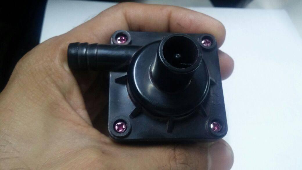 12V DC 8watt Brushless Water Pump And Solar Pump - shown as a black plastic unit held in a hand, featuring a side outlet port and a top intake nozzle.