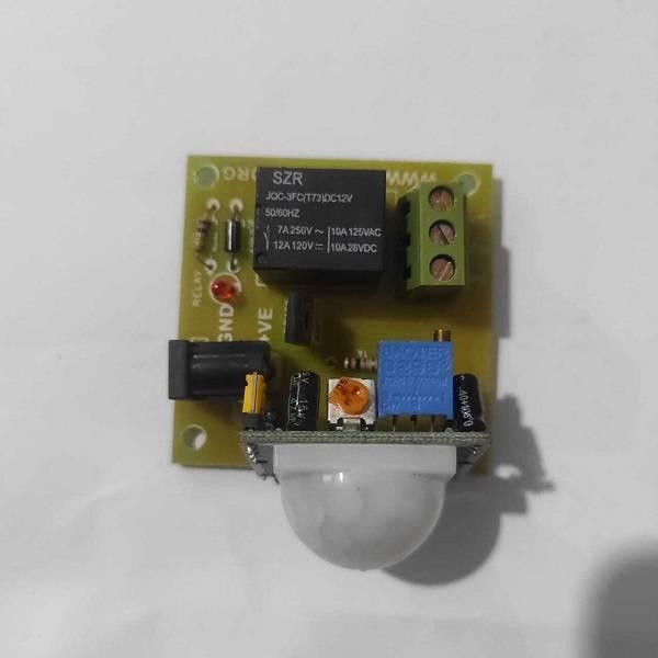 12V PIR Motion Sensor Switch Module - a white dome sensor, a black relay, a DC power jack, a green screw terminal, and two blue adjustment knobs.