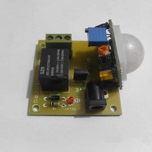 12V PIR Motion Sensor Switch Module - a green circuit board with a white dome sensor, a black relay, a power jack, and a red indicator LED.